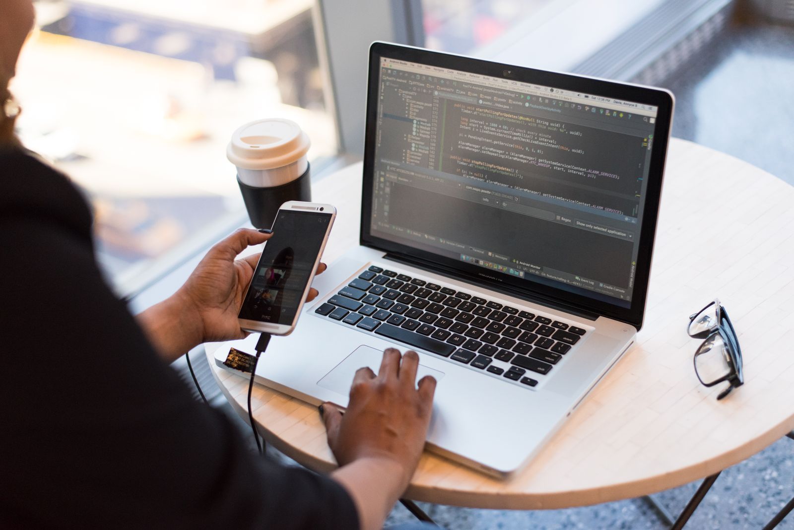 A handheld device tethered to a laptop, being read