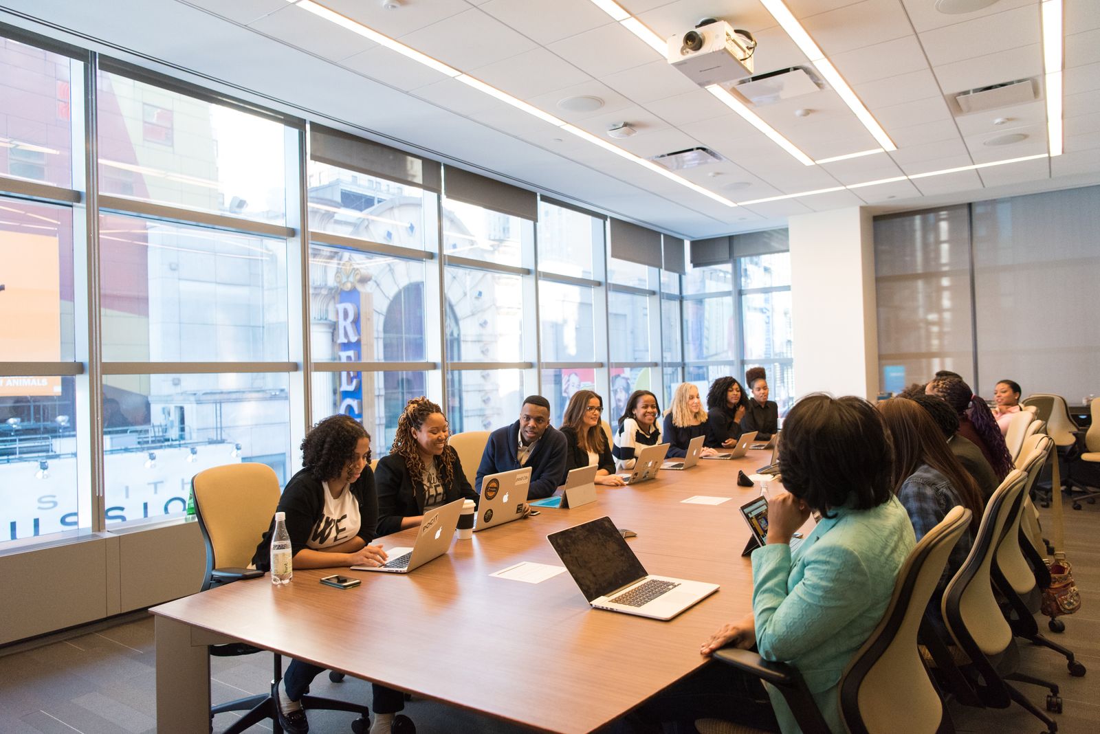 A boardroom meeting beside full-height windows