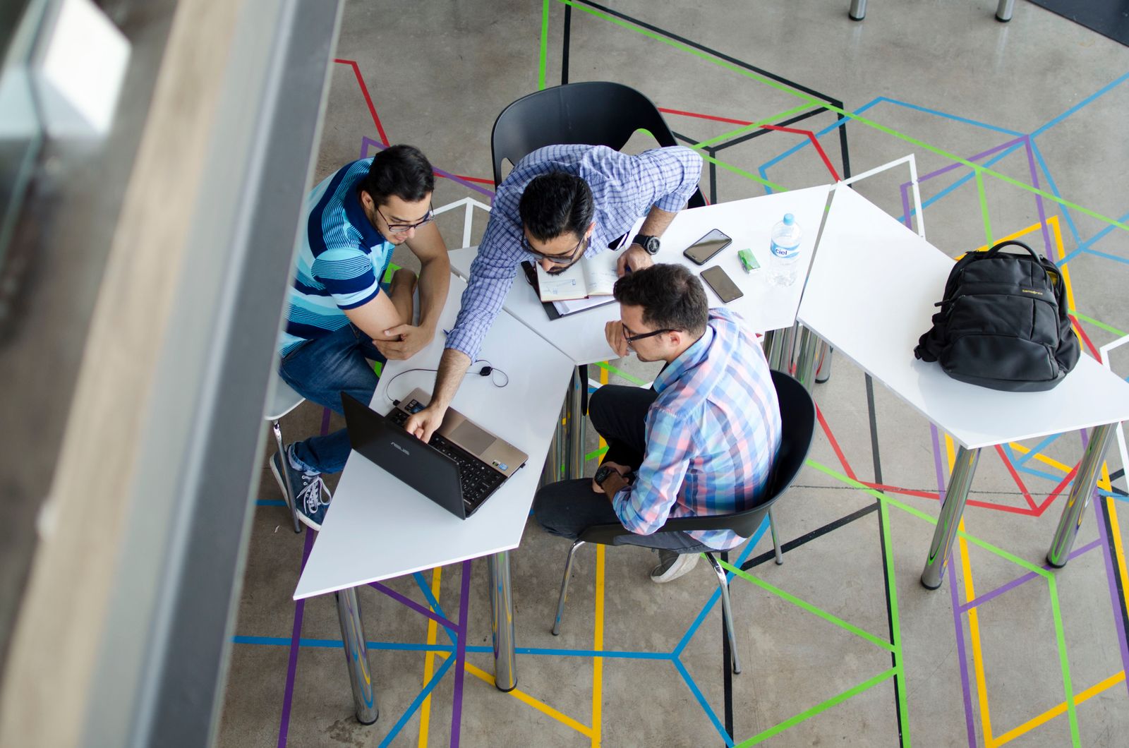 A team working across shared tables, seen from above