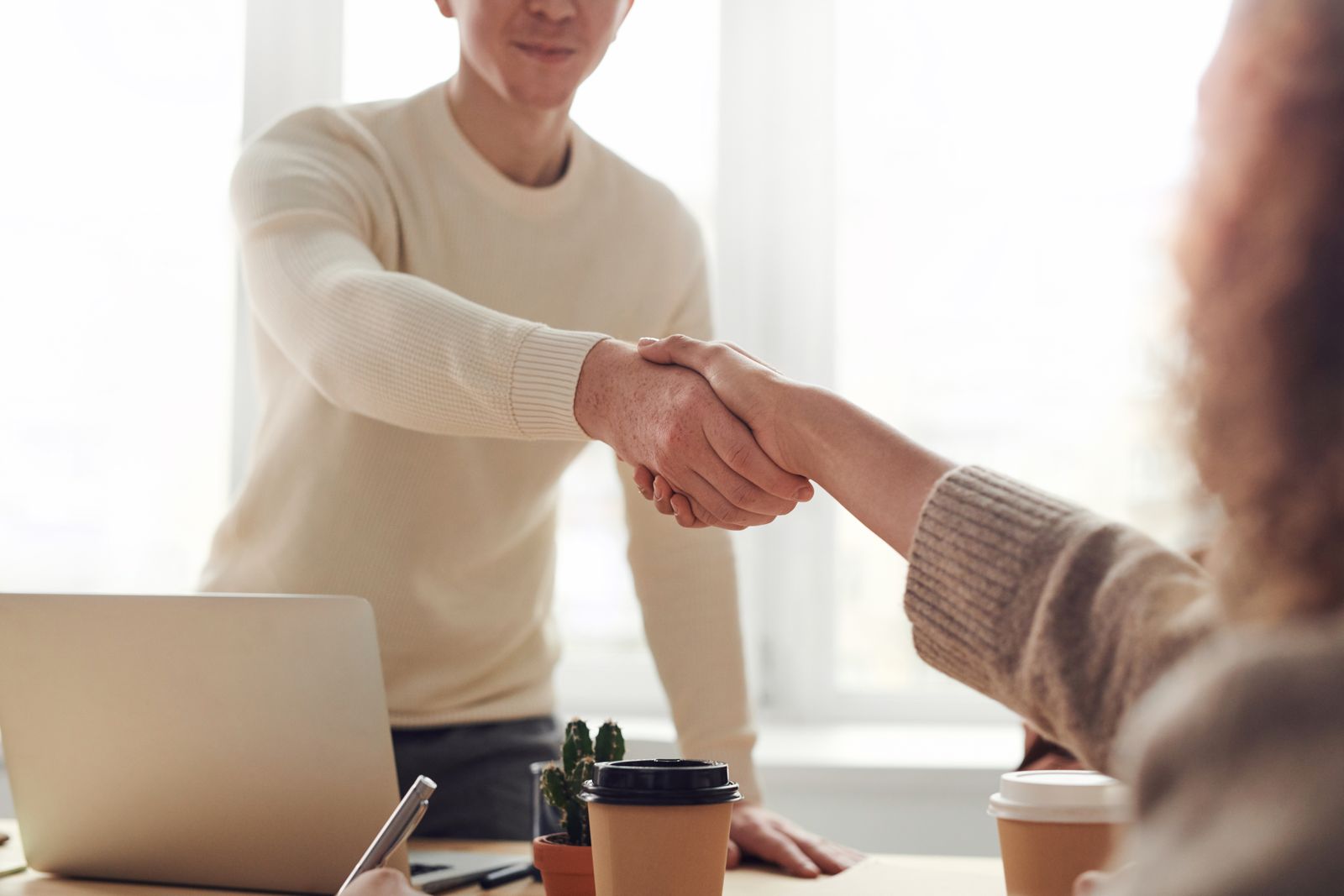 A handshake across a desk