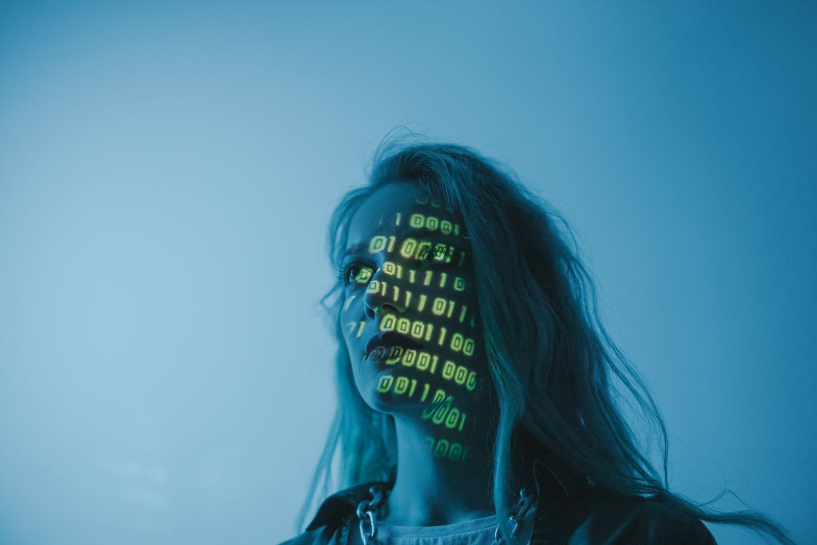 A face with binary digits projected across it